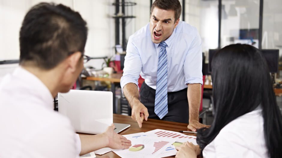 frustrated manager shouting on employees showing reports