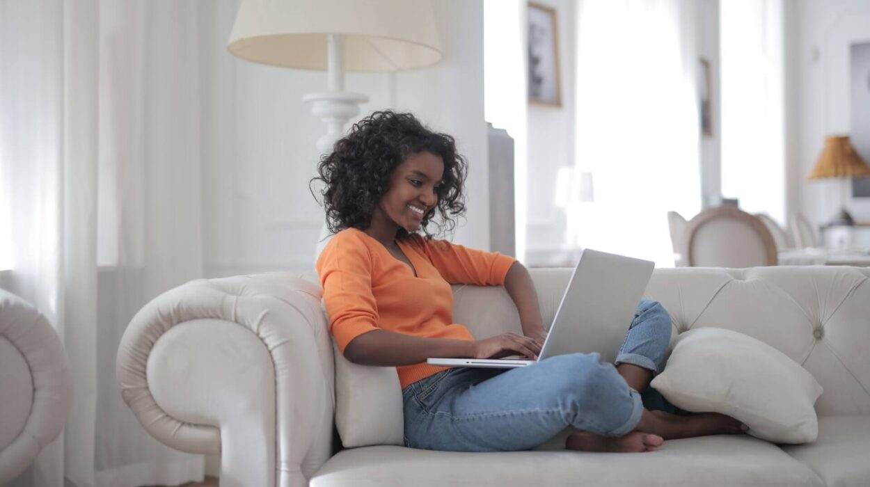 young female remote worker with laptop from home.