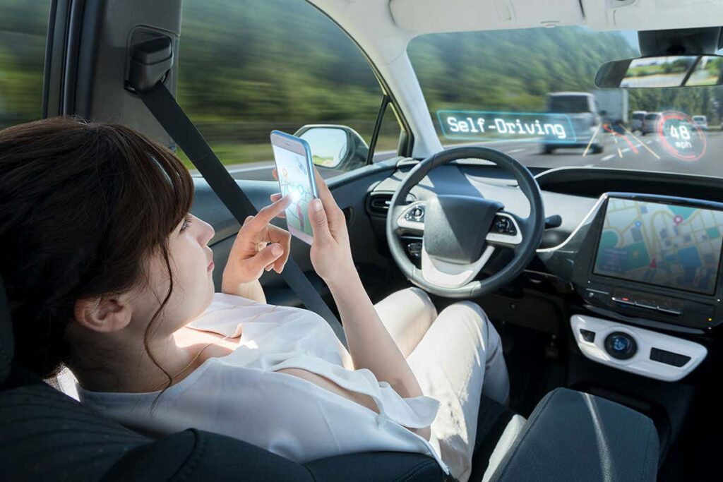 Woman setting navigation from mobile on a self driving car