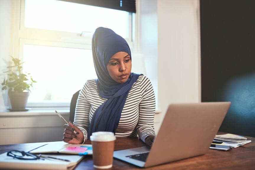 A woman looking at her Interfiling EB3 to EB2 status on laptop